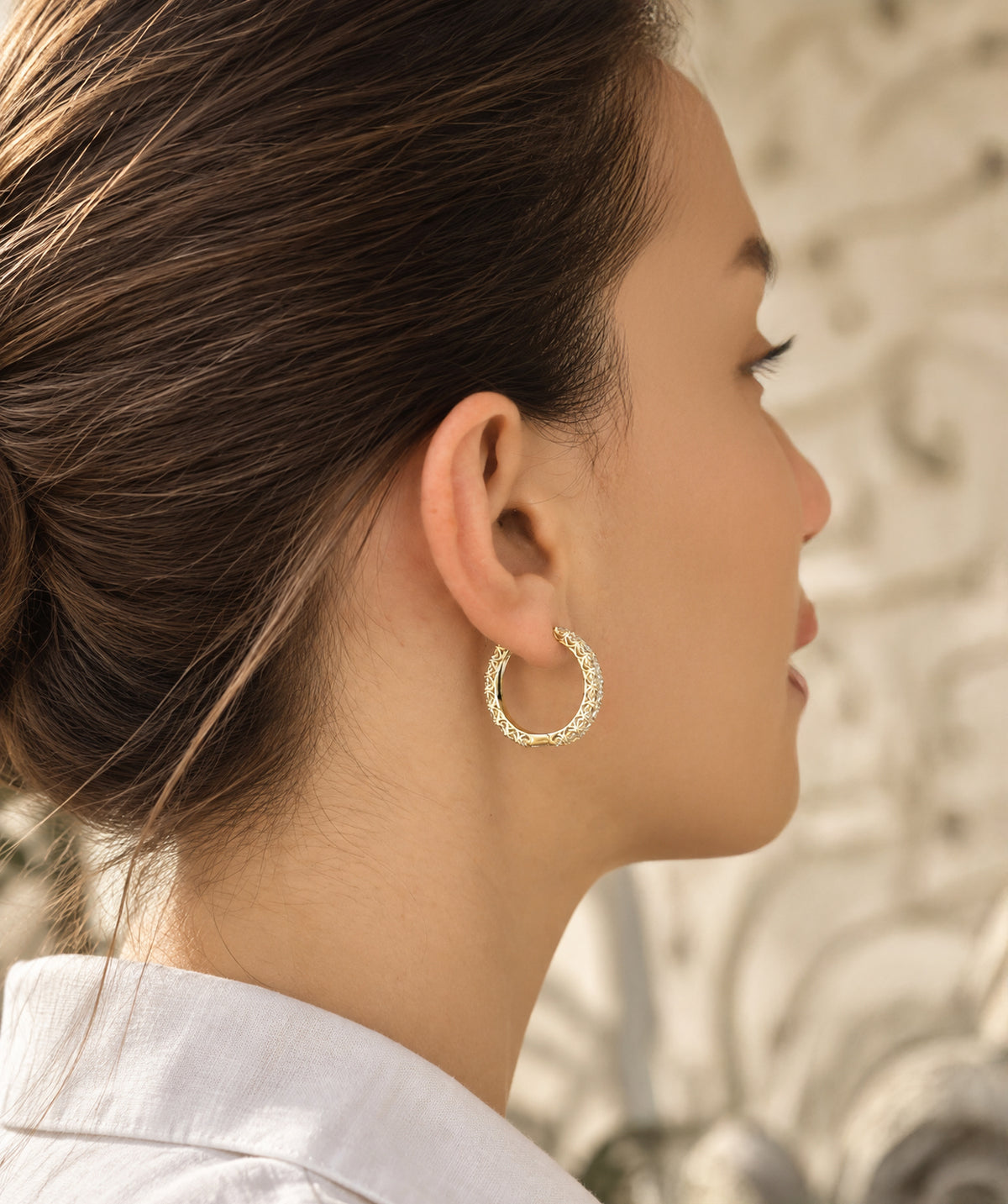 Model wearing the Medium Pavé Hoop Earrings on the ear