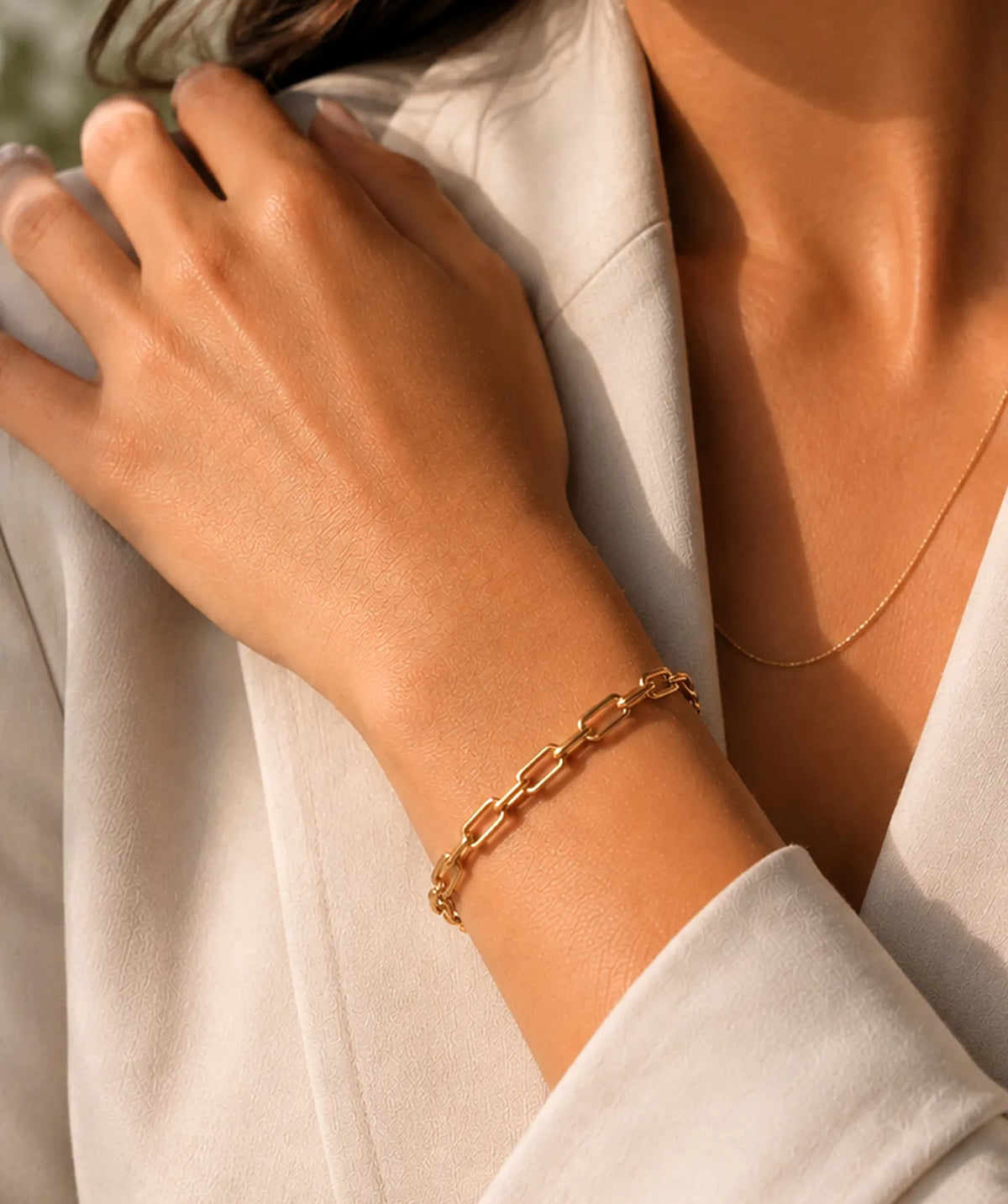 Model wearing the Women's Gold Paperclip Chain Bracelet on the wrist