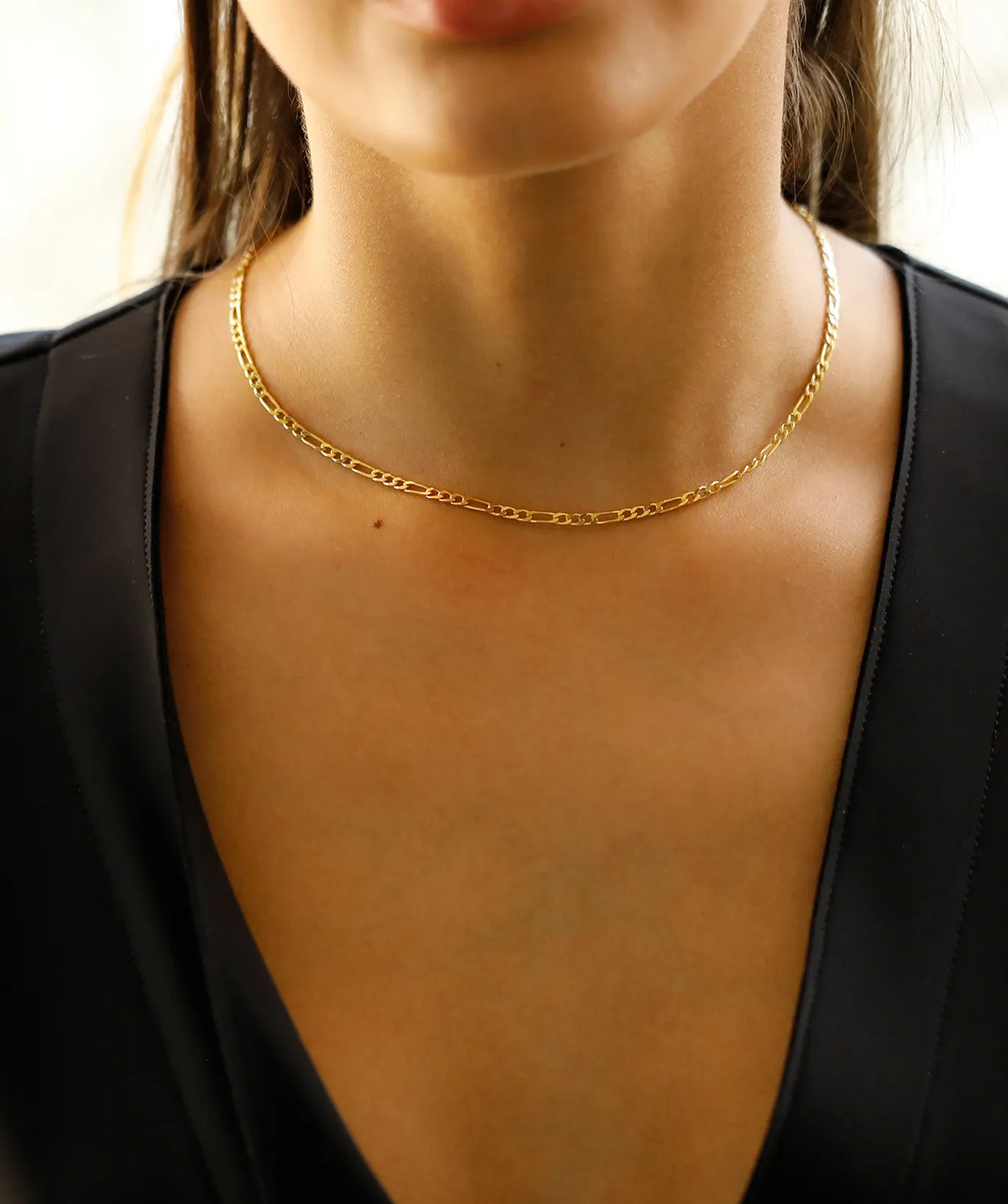 Model wearing the Gold Figaro Chain around the neck