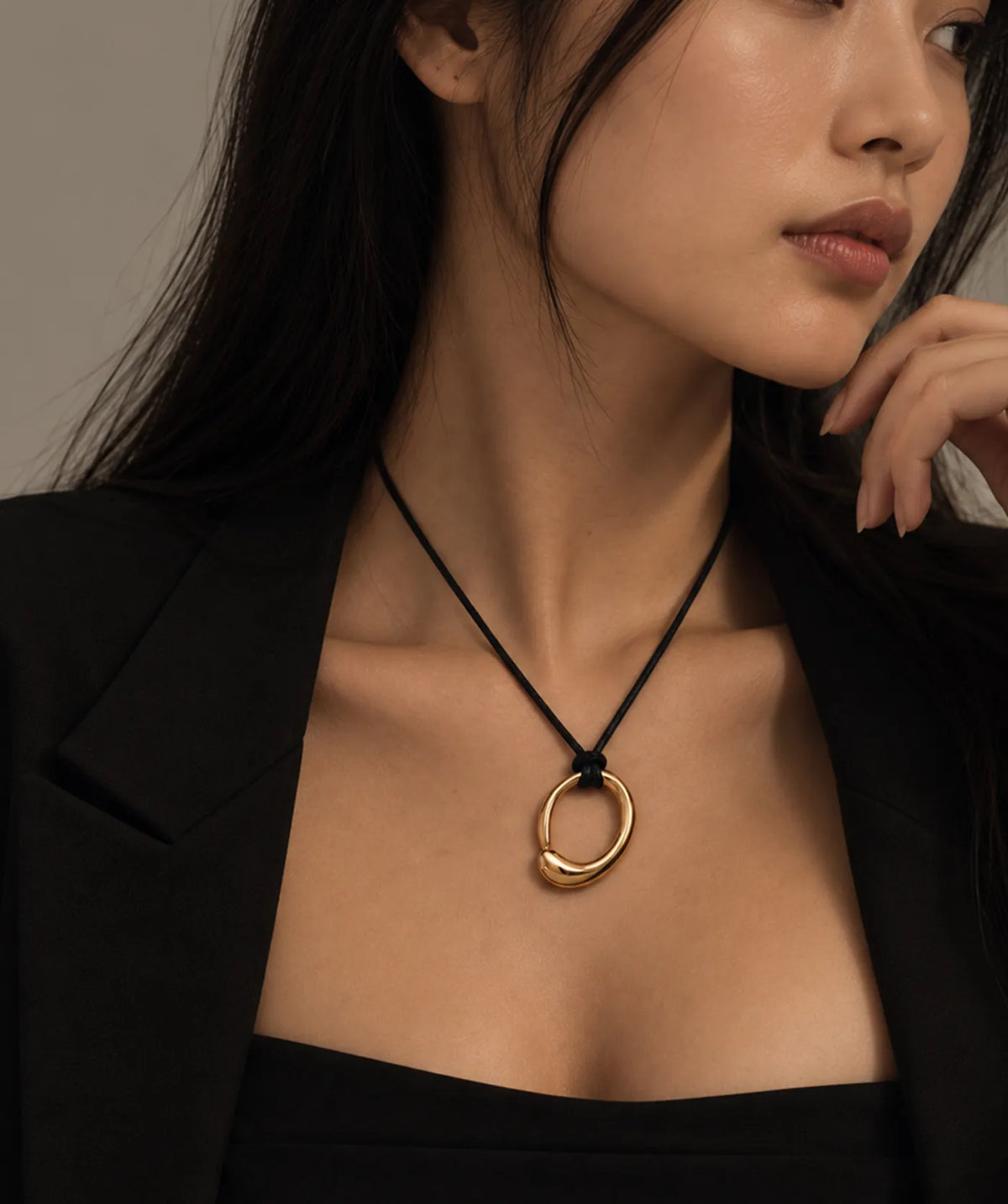 Model wearing the Gold Leather Necklace around the neck