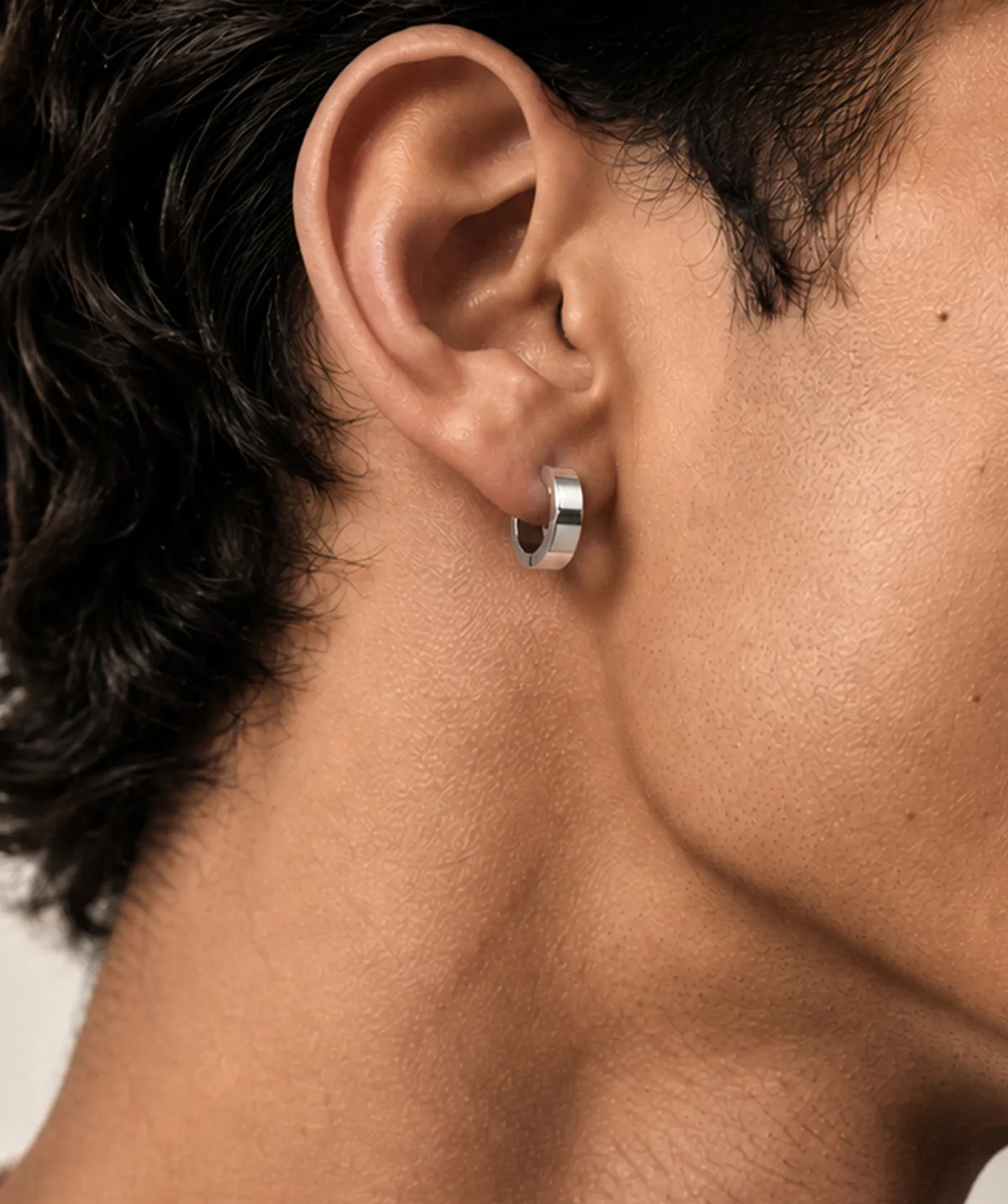 Model wearing the Silver Thick Round Flat Hoop Earrings on the ear