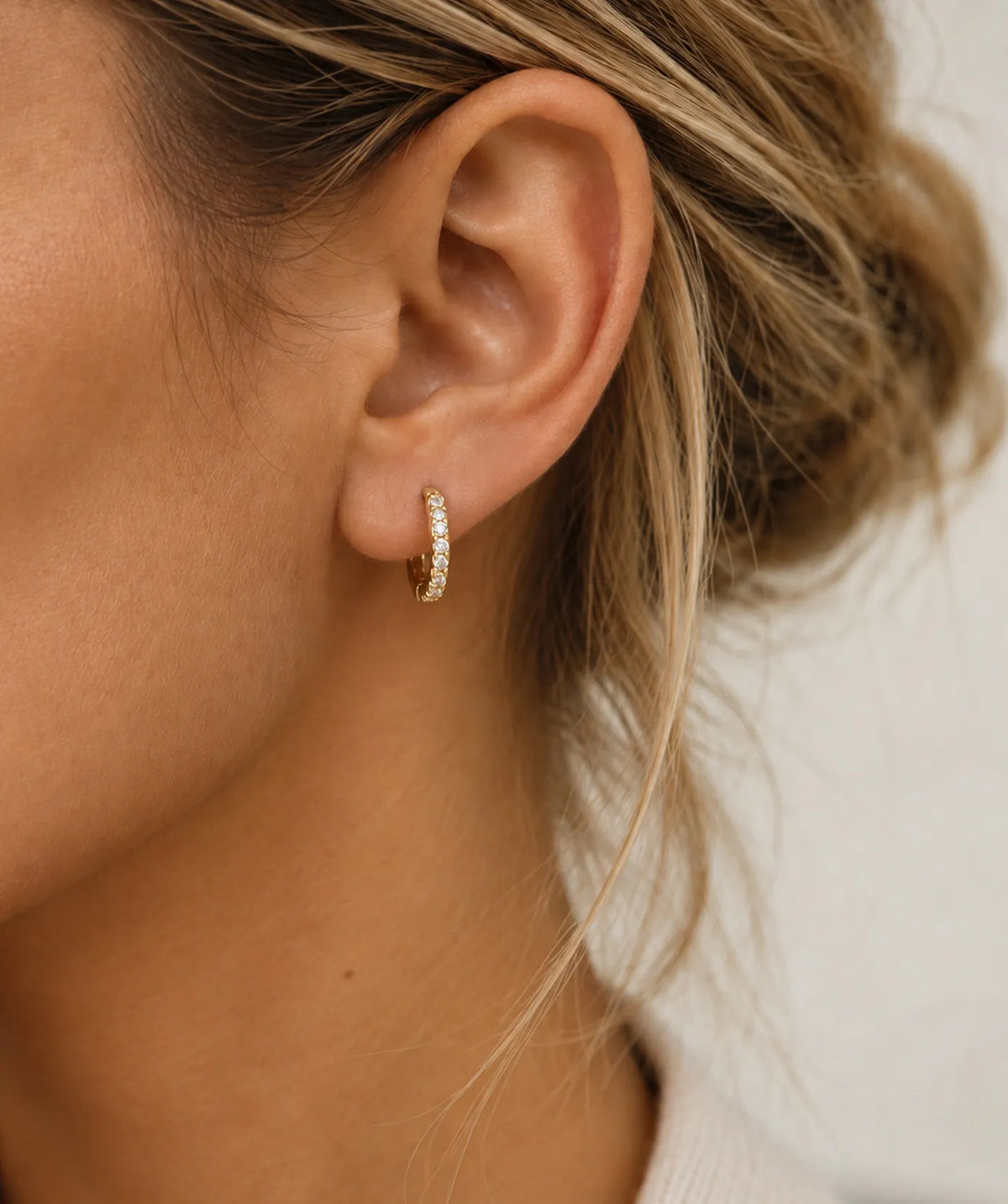 Model wearing the Gold Small Pavé Hoop Earrings on the ear