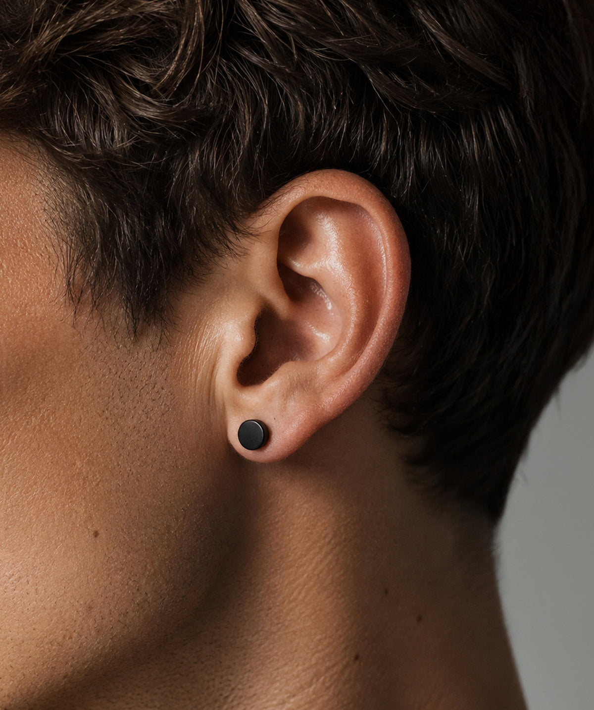 Man wearing the Black Butterfly Stud Earrings on the ear