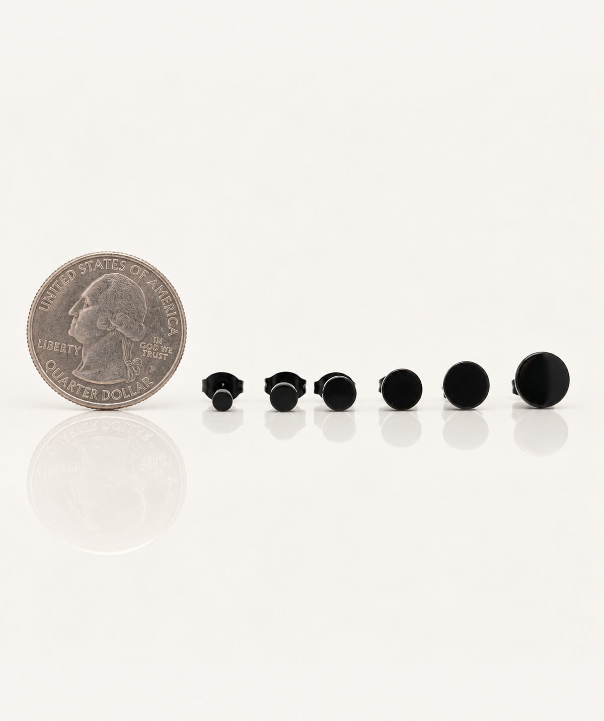 Black Butterfly Stud Earrings next to a coin for size reference