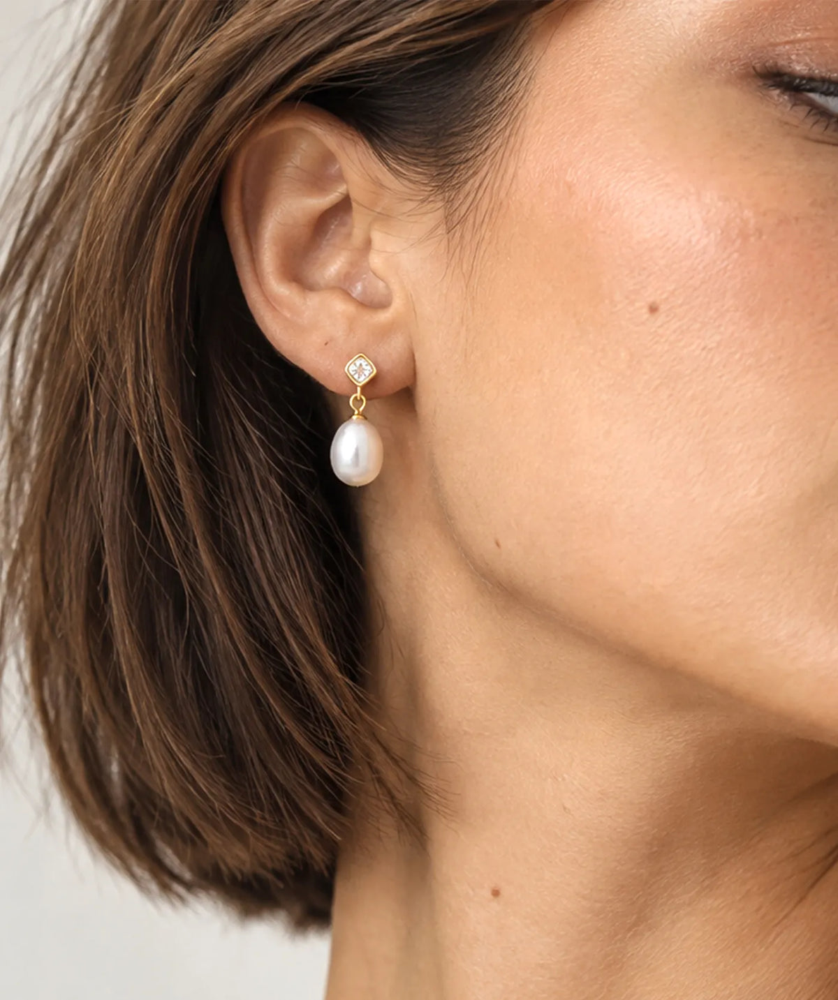 Model wearing the Gold Pearl Drop Stud Earrings on the ear