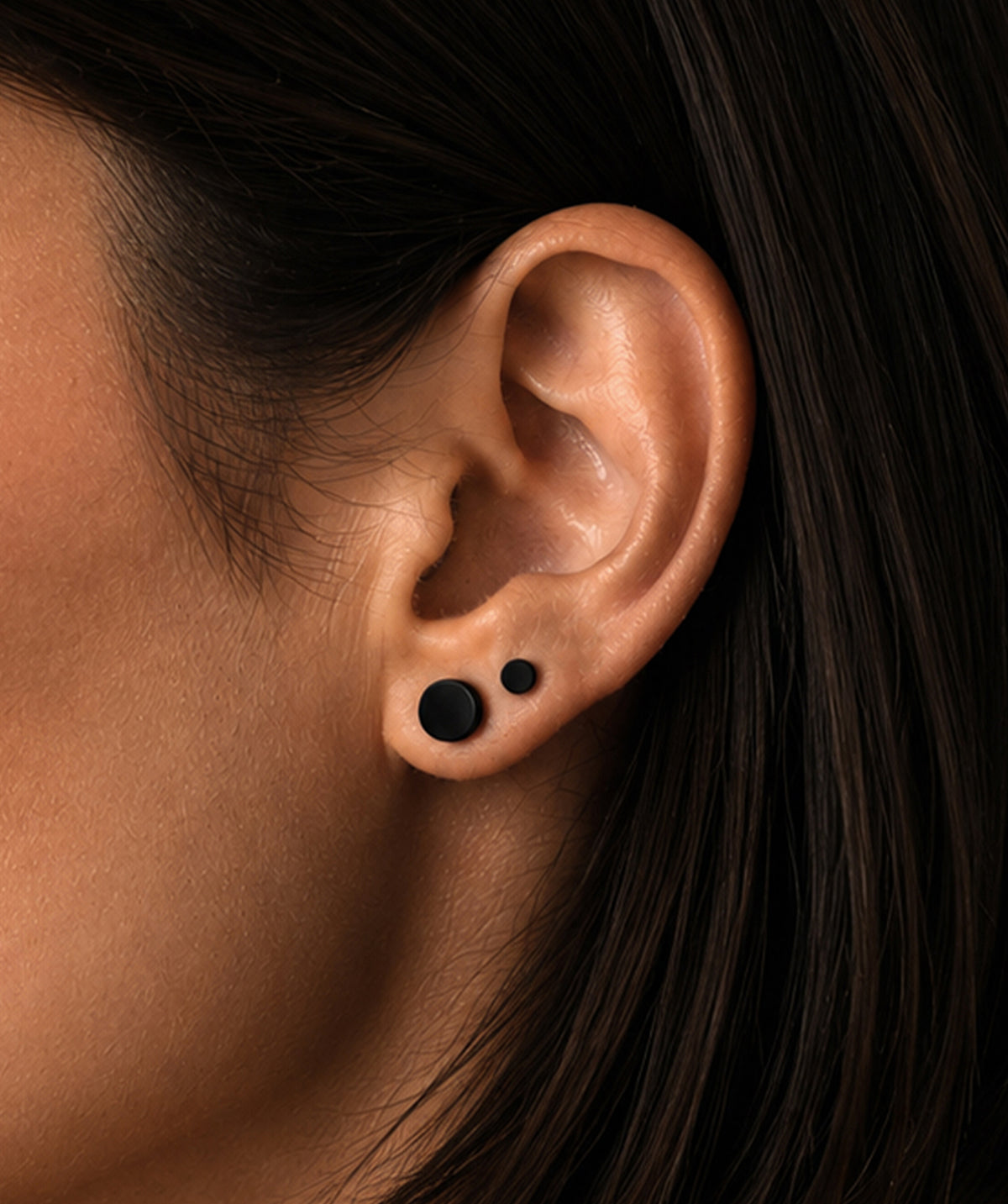 Model wearing the Black Screw Back Stud Earrings on the ear