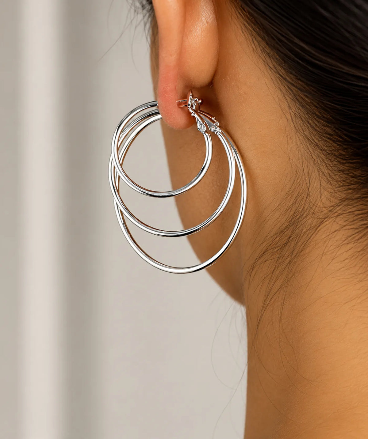Model wearing the Silver Endless Large Hoop Earrings on the ear