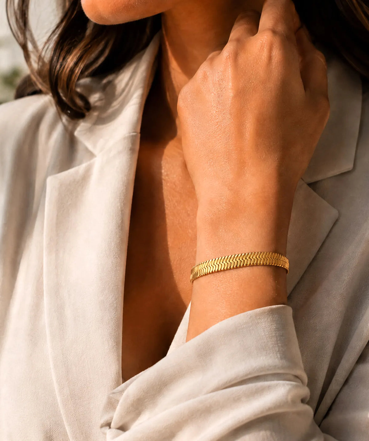Model wearing the Women's Gold Herringbone Chain Bracelet on the wrist