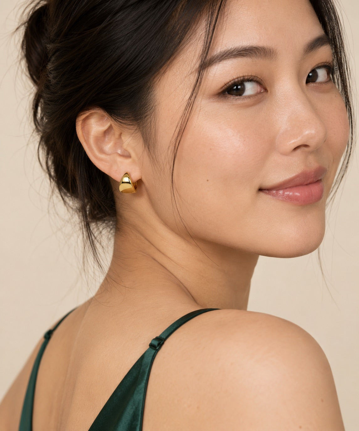 Gold Wide Tapered Huggie Earrings on model